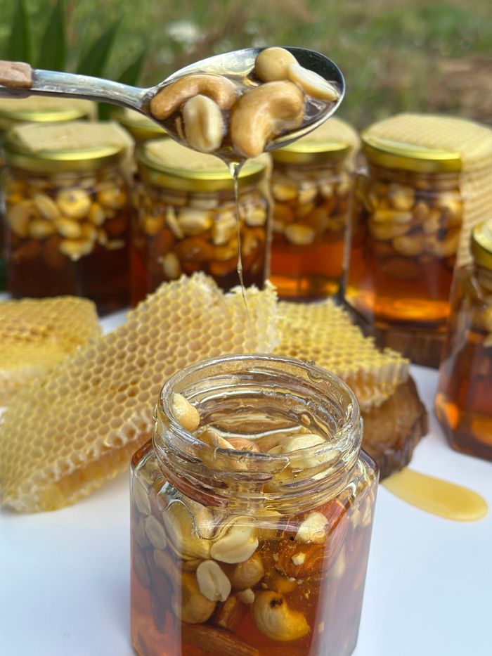 why-choose-us-02 Jars of honey and nuts with honeycomb, showcasing rich textures and natural sweetness.