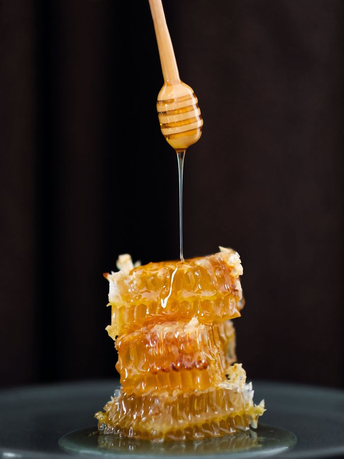 why-choose-us-01 Delicious honey dripping from a dipper onto honeycomb. Perfect for food and nature themes.